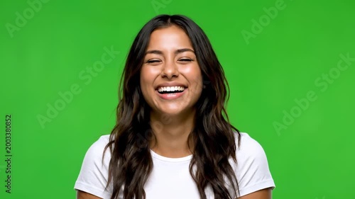 Radiant Expression of pure Joy: A portrait of a woman's genuine happiness, her eyes closed in a moment of pure bliss and laughter. The image exudes a sense of peace, contentment, and authentic joy.