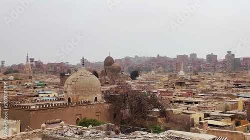 Panoramic view of cairo's city of the dead, al qarafa, revealing its historic necropolis and ancient islamic architecture