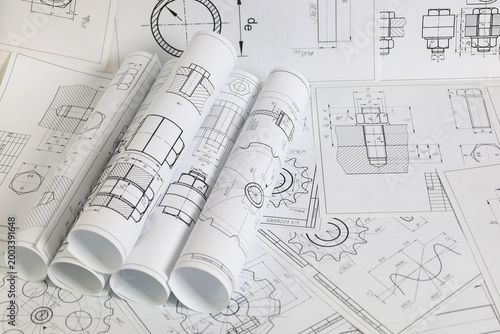 paper engineering drawings of industrial parts and mechanisms