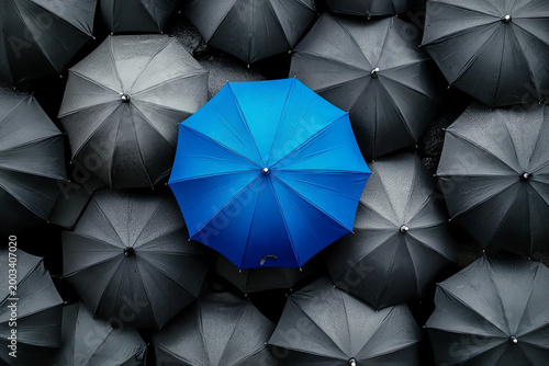 Blue Umbrella Standing Out Among Gray Umbrellas – Symbol of Innovation and Leadership