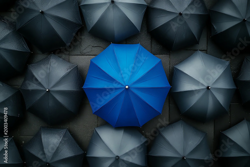Blue Umbrella Standing Out Among Gray Umbrellas – Symbol of Innovation and Leadership