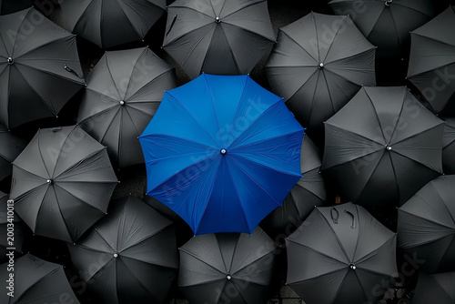 Blue Umbrella Standing Out Among Gray Umbrellas – Symbol of Innovation and Leadership