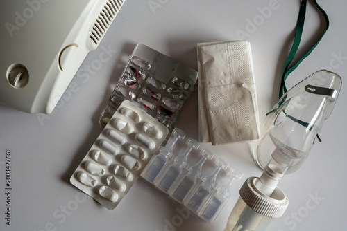 Schilderij op canvas Inhalation set featuring a white compressor nebulizer, transparent oxygen mask,