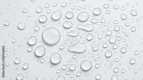 Abstract pattern of clear transparent water drops and droplets on a light gray smooth surface, background for purity and freshness concept as PNG asset