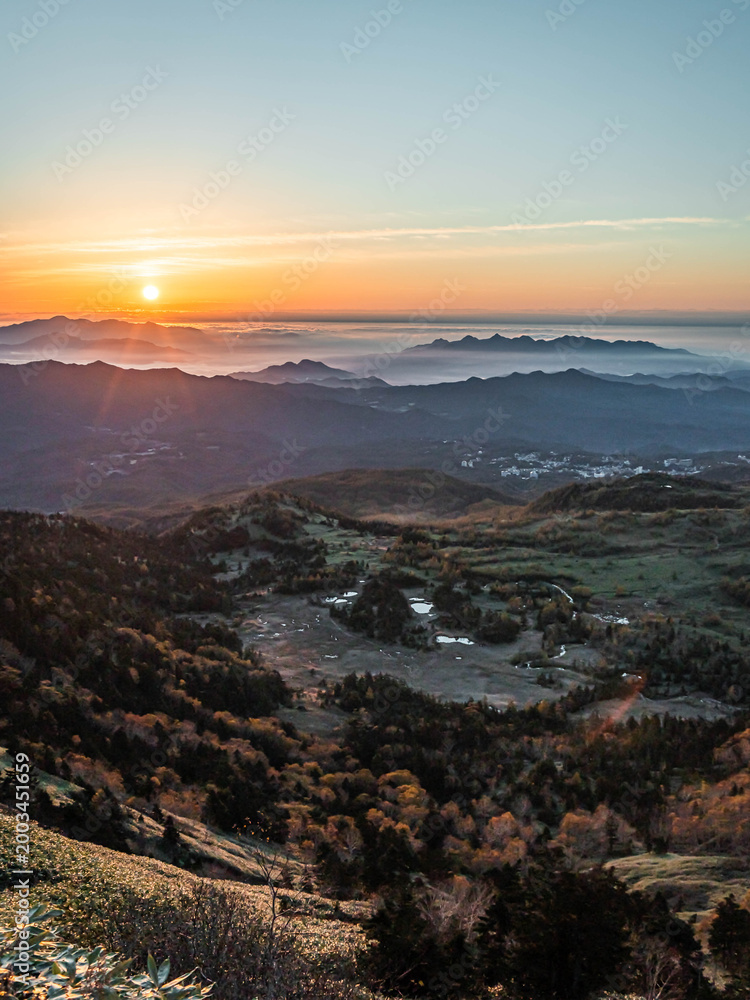 Fototapeta premium Sunrise over misty mountain valley with sea of clouds, autumn landscape in Japan