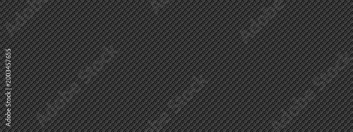Luxury woven kevlar creates seamless industrial backdrop. Dark geometric textile with metallic threads forms modern automotive surface, ideal for tech presentations and sport applications.