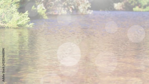 Diagonal wipe starting reveal, bokeh fading down, water ripples focusing to show bank reflections