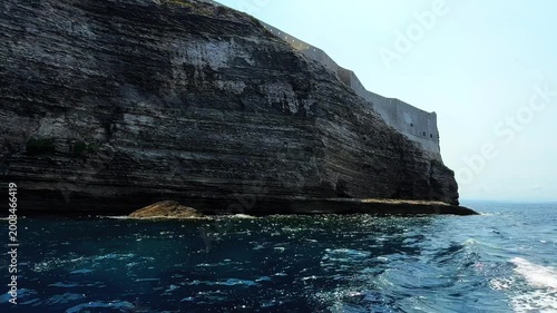 Massive white limestone cliffs of Bonifacio rising vertically from the turquoise sea