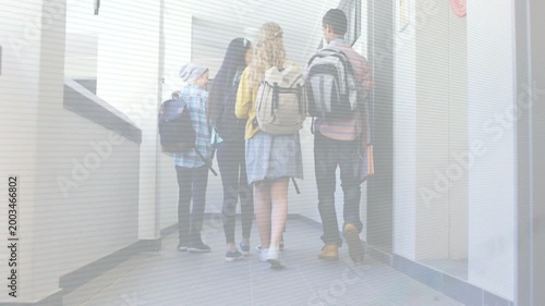 Four students walking down hall during school class change, backpacks on, animated arrow guiding