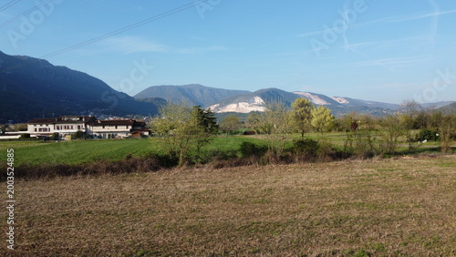 High-voltage electricity pylon in a rural landscape with industrial area