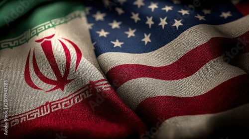 Close up of the Iranian and American flags intertwined, symbolizing complex geopolitical relations and diplomacy between nations.