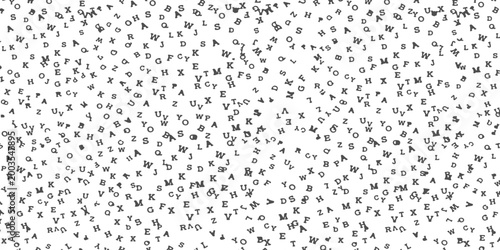 Black letters scattered randomly on a plain surface creating a textured alphabet pattern