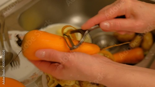Man woman washing vegetables in sink vidga potatoes carrot hand movement products water faucet stainless steel sink