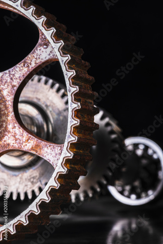 Gearbox clutch shaft and a timing shaft gear wheel with visible wear, symbolizing mechanical work, cooperation, and synchronization in an industrial environment