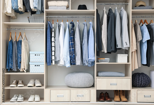 Bild auf Leinwand Wardrobe with different stylish clothes, accessories, shoes and home stuff indoo