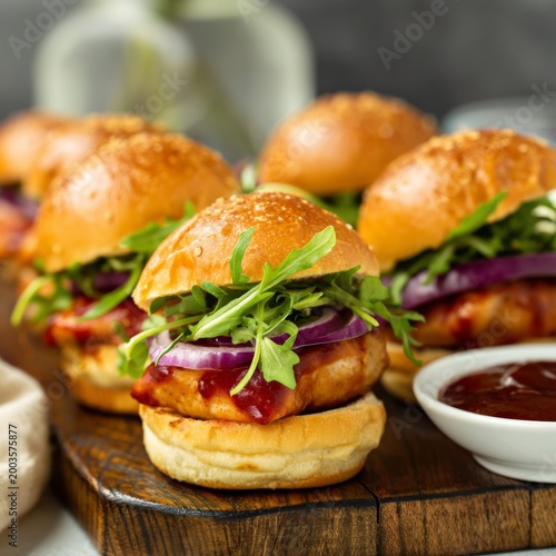 Grilled Chicken Sliders With Barbecue Sauce Served on Wooden Board During Aft...