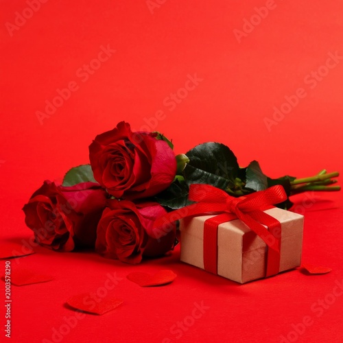 Roses and Gift Box on a Red Background for a Celebration of Love and Affection