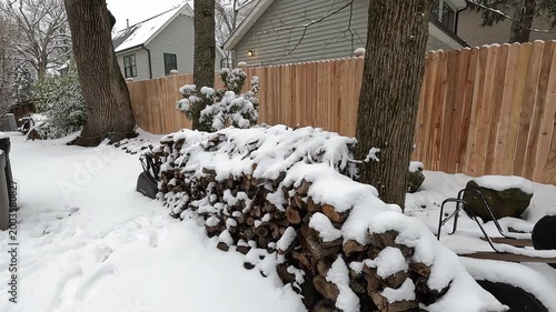 wood pile, backyard and house covered with snow after the snow storm in February