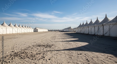 Expansive Rows of White Tents in Desert Landscape Under Clear Blue Sky