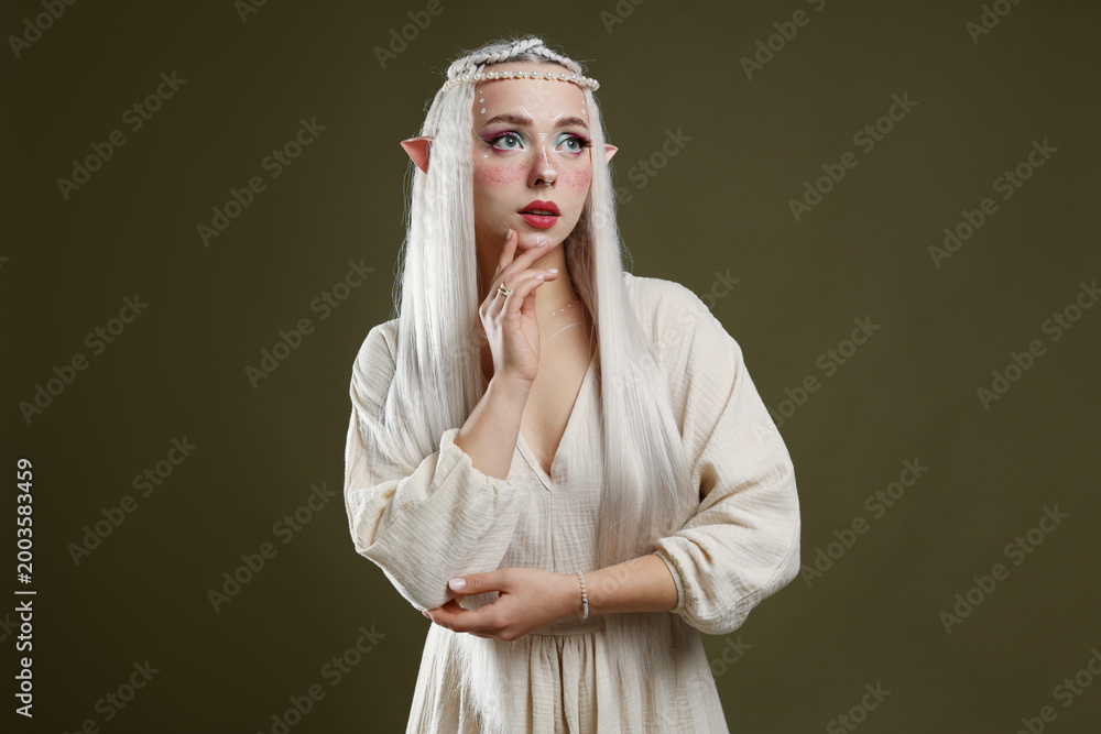 Fototapeta premium Beautiful elf girl on dark olive background