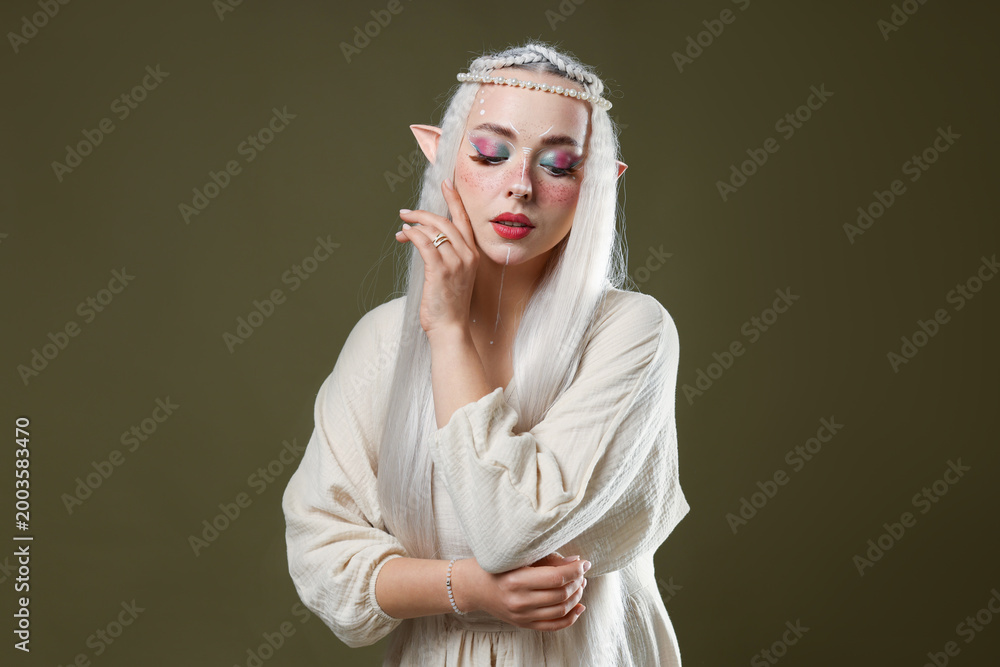 Fototapeta premium Beautiful elf girl on dark olive background