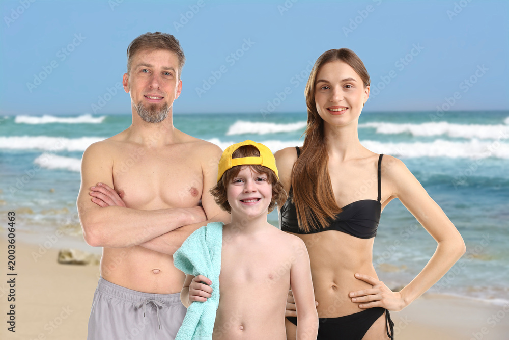 Fototapeta premium Happy family with son on beach near sea
