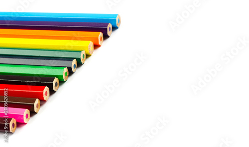 Colored pencil ends in row with copy space on white
