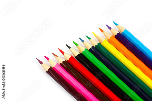Sharpened colorful pencil tips fanned on white background