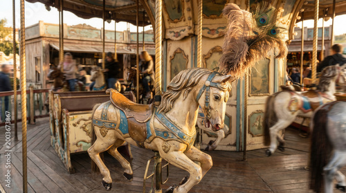 Vintage carousel horse with ornate details on amusement park ride  