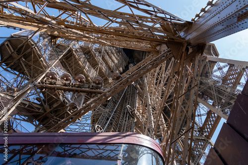 Top of an Eiffel tower elevator ascending through intricate metalwork