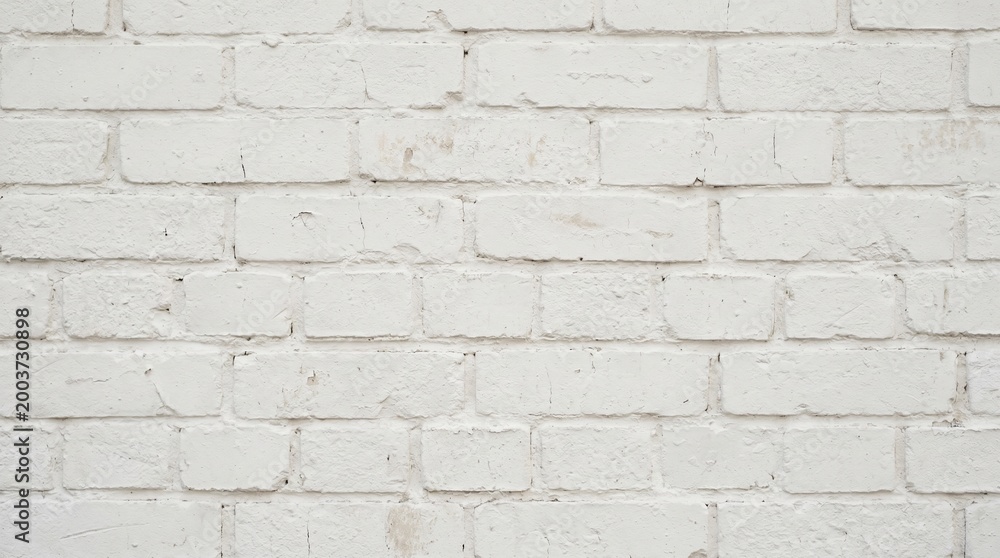 Obraz premium A close-up view of a white brick wall with rough texture