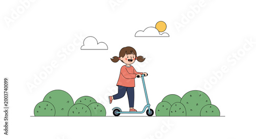 Little girl with pigtails having fun while riding blue kick scooter in park with green bushes under sunny sky with clouds.