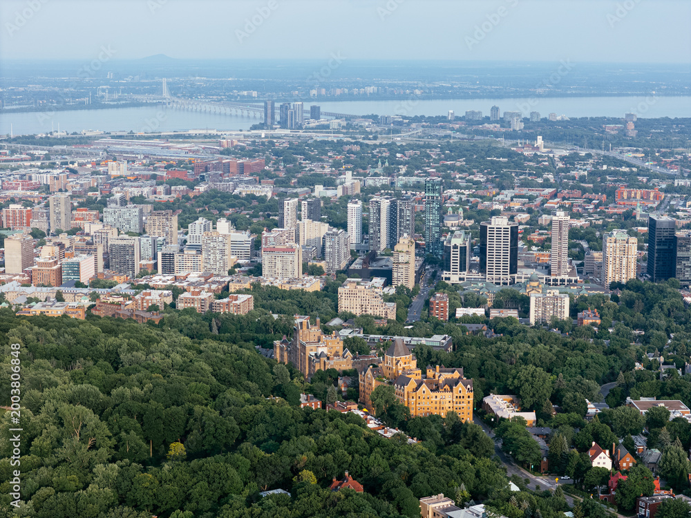 Obraz premium Montreal downtown skyline from Mount Royal with park, lake and greenery in summer, Quebec, Canada. g.