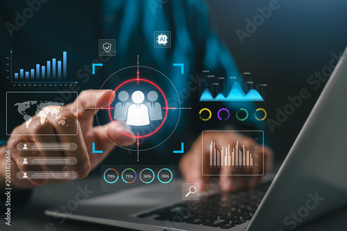 Professional utilizing laptop for CRM customer relationship management business strategy data analysis marketing automation client retention, touching holographic digital analytics interface