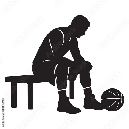 Basketball player taking a moment of reflection on bench