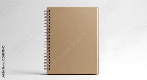 Single closed spiral bound notebook with a plain tan cover isolated on white background