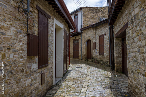 Rustic Stone Alley with Wooden Shutters