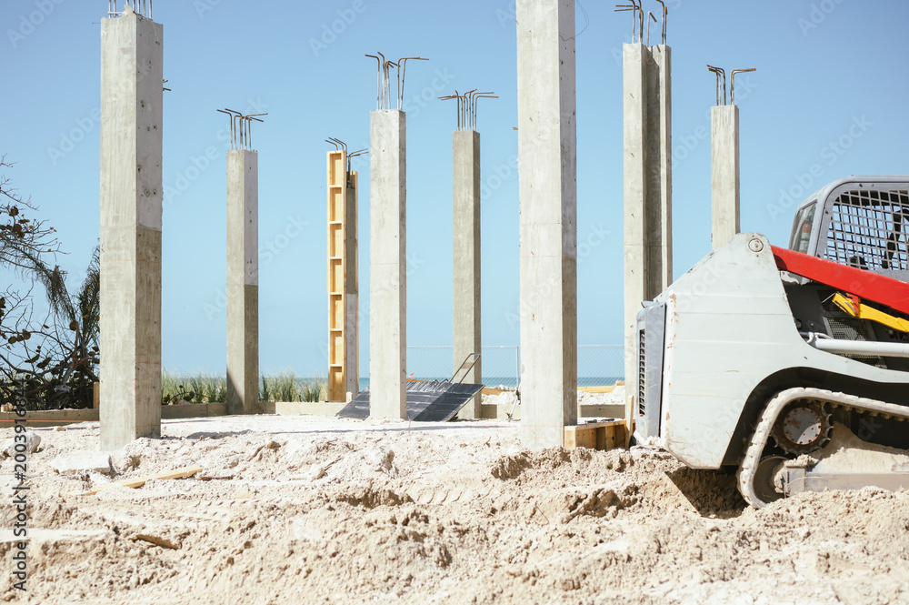 Fototapeta premium Concrete columns and machinery at Anna Maria Island build site