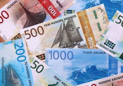 Norwegian krone money bills pile on table. Norway banknotes of NOK currency close up.