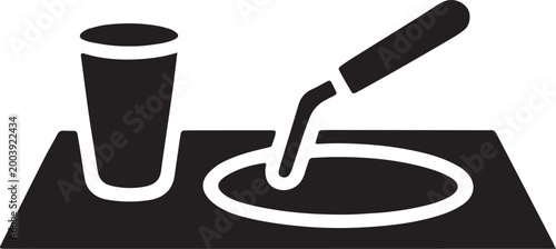 Masonry trowel spreading mortar with a cup for water on surface with clean in outline