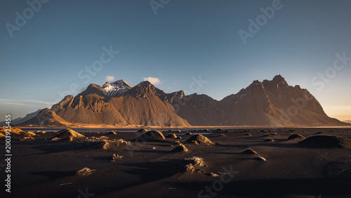 Fotografie Golden sunrise at Vestrahorn mountains and Stokksnes in Iceland, famous place to