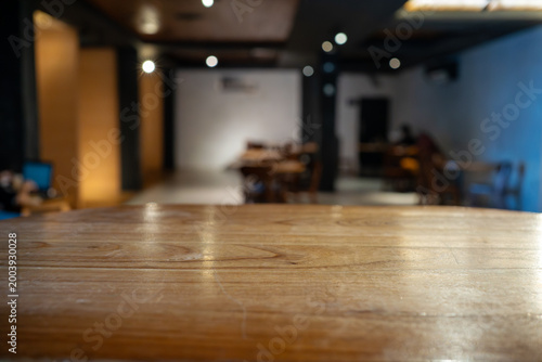 Empty wooden table with blurred cafe interior background