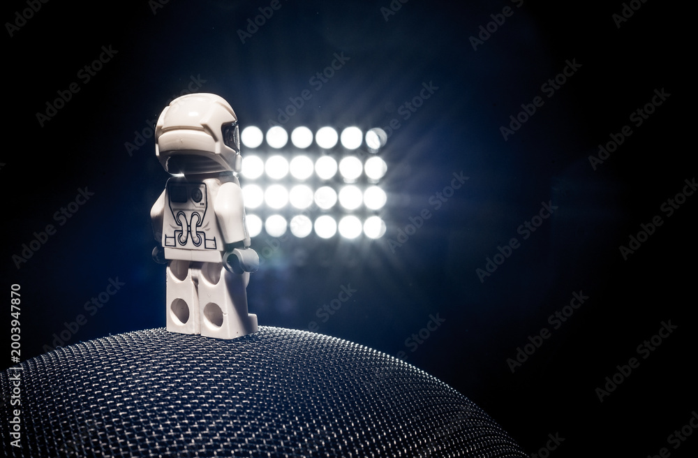 Fototapeta premium Gothenburg, Sweden - October 04 2017: Miniature astronaut standing on textured sphere under bright lights.