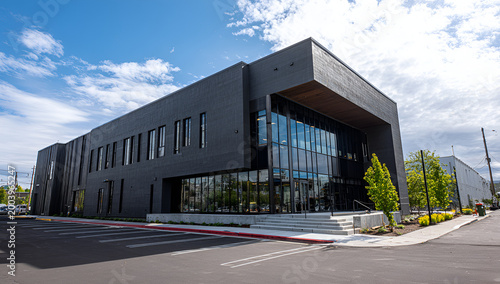 Modern Office Building Exterior with Glass Facade and Blue Sky.