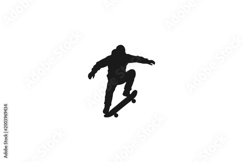 Φωτογραφία Silhouette of a skateboarder jumping performing an ollie trick