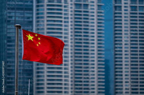 the Chinese flag with skyscrapers of Pudong in the back