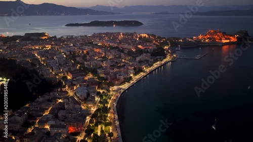 Majestic aerial night view of Corfu Town and Old Fortress. Illuminated historical architecture, Old Town streets, and Ionian sea coastline at dusk, Kerkyra, Greece