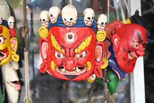 Traditional hand-carved Tibetan masks with vibrant colors.