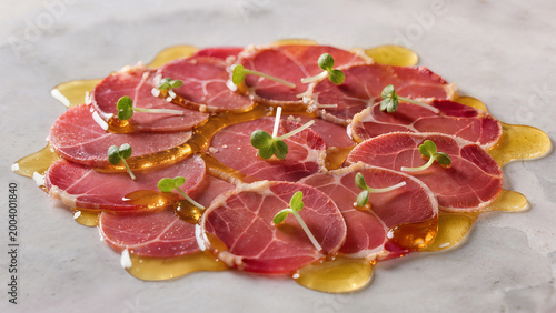 Sliced meat with sauce and garnish served on a white plate in a restaurant during lunch hour Generative AI