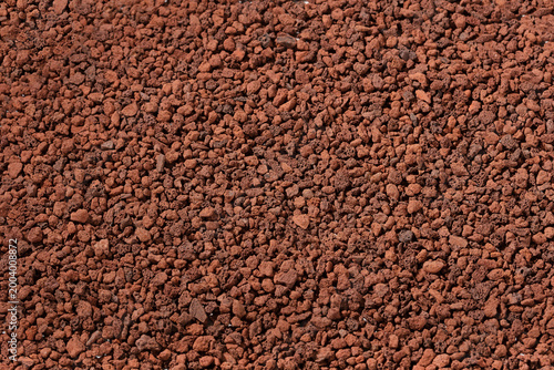 Fotografie Close up of natural red volcanic rock scoria gravel texture for landscaping and garden mulch